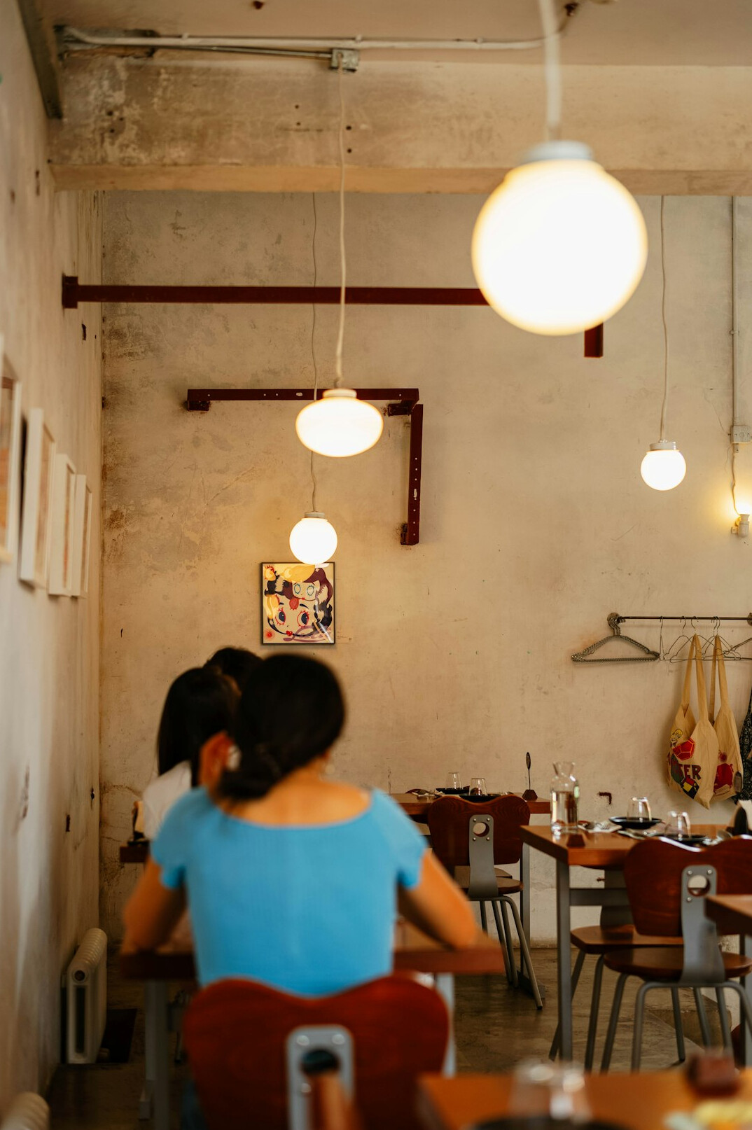 Two Mexican friends having a warm conversation at a cafe table