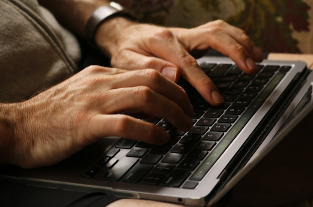 person typing on laptop