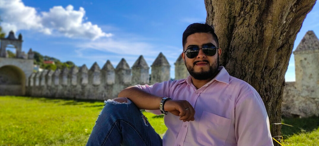 Portrait of a Mexican man with a beard and glasses